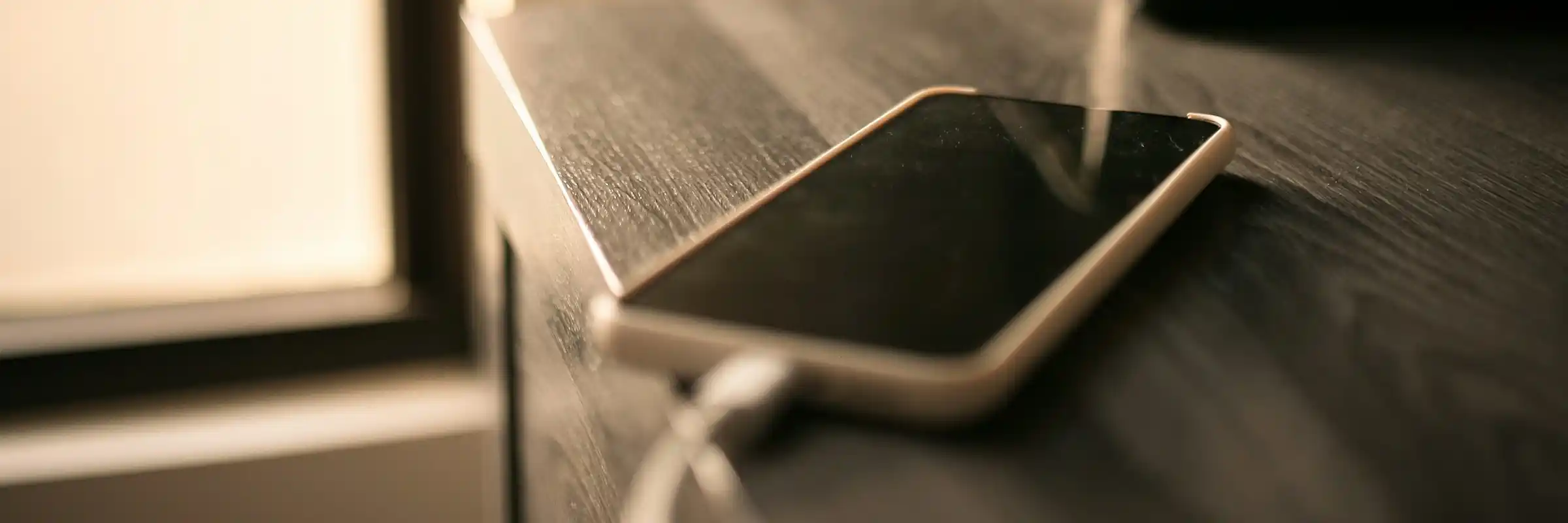 Artesia Crossings Apartments cell phone on table by window